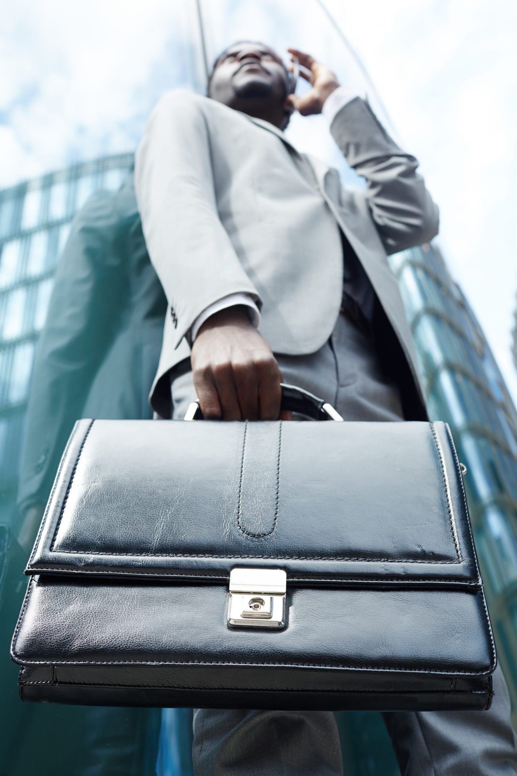 Carrying briefcase Leather briefcase in hand of modern salesman